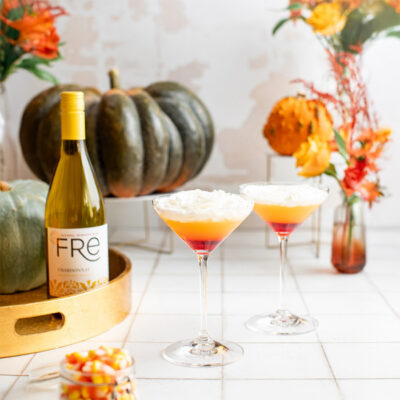 color image of a bottle of FRE Alcohol-Removed Chardonnay with 2 cocktails resembling candy corn