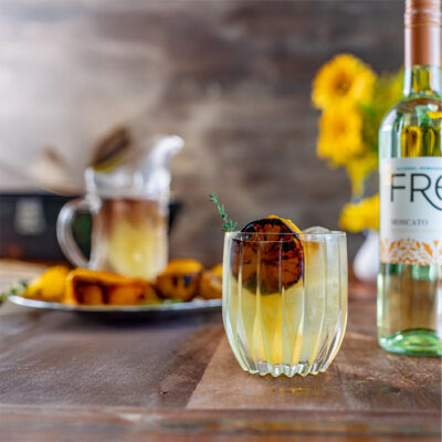 color photo of a bottle of FRE Alcohol-Removed wine next to yellow cocktail