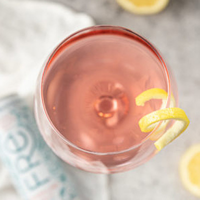 Birds eye view of a pink cocktail with lemon twist